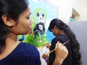 17 Girls painting mural